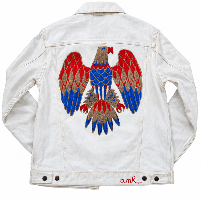 Custom chainstitch embroidery on a vintage white denim jacket, featuring a large eagle back design with outstretched red and blue wings, gold detailing and intricate stitching by amR