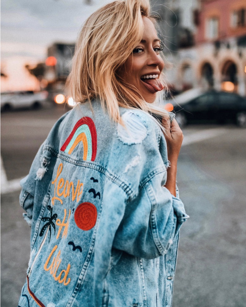 Custom denim jacket created for Aggie Lal with colorful embroidered back artwork and western-inspired details
