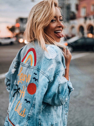 Custom denim jacket created for Aggie Lal with colorful embroidered back artwork and western-inspired details