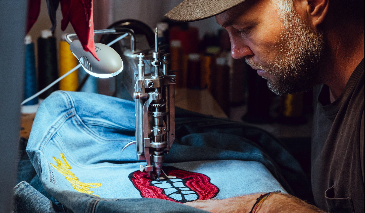 Live chainstitch embroidery by amR on a denim jacket at an event in Los Angeles, CA