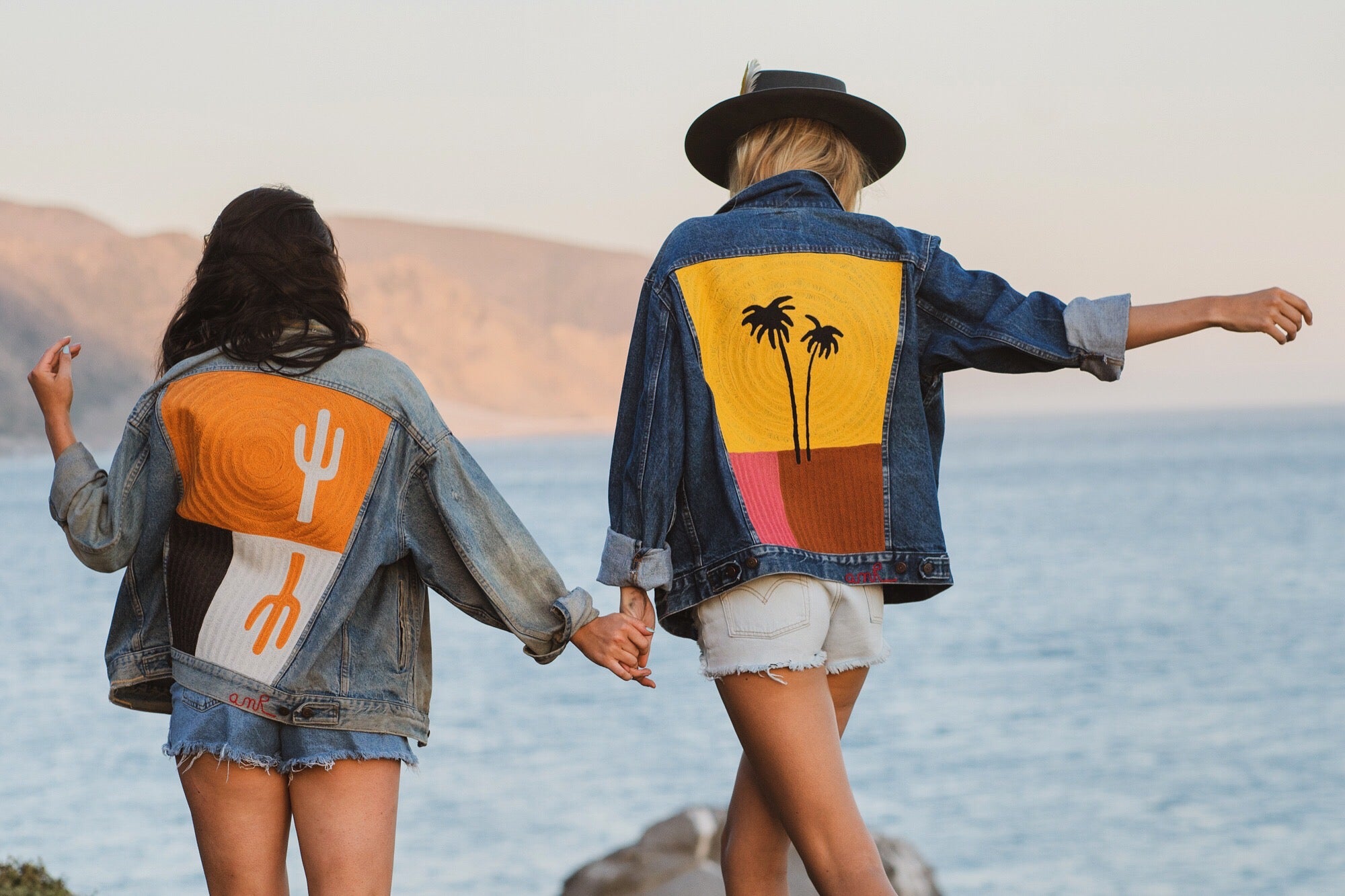 Two custom denim jackets with chainstitch embroidery by amR, featuring cactus and palm tree back designs