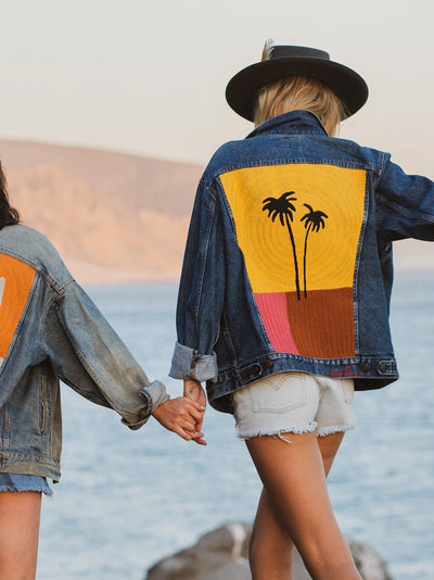 Two custom denim jackets with chainstitch embroidery by amR, featuring cactus and palm tree back designs