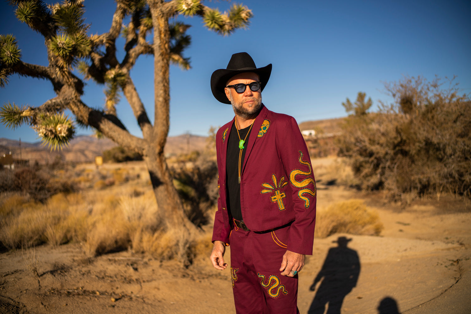 Custom chainstitch embroidered burgundy suit with Western motifs in Joshua Tree, California
