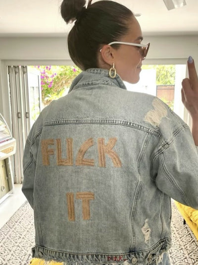 Woman wearing a custom denim jacket with chainstitch embroidered back lettering by amR in Sydney