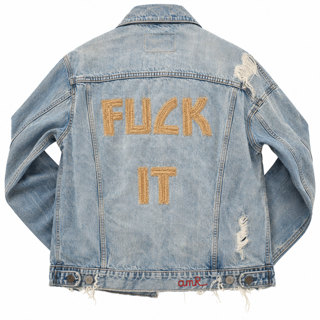 Custom chainstitch embroidery on a vintage-style distressed denim jacket, featuring oversized gold-toned FUCK IT lettering with raised textured stitching, frayed details and a bold statement back design by amR Los Angeles