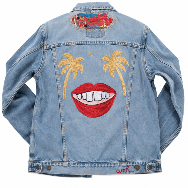 Custom chainstitch embroidered denim jacket featuring golden palm trees and bold red smiling lips on the back, a bespoke embroidery design by AMR