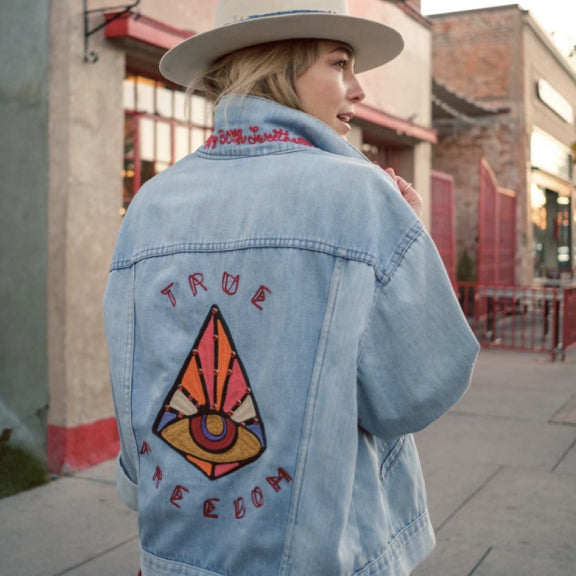 Custom embroidered denim jacket by amR with hand-guided chainstitch artwork