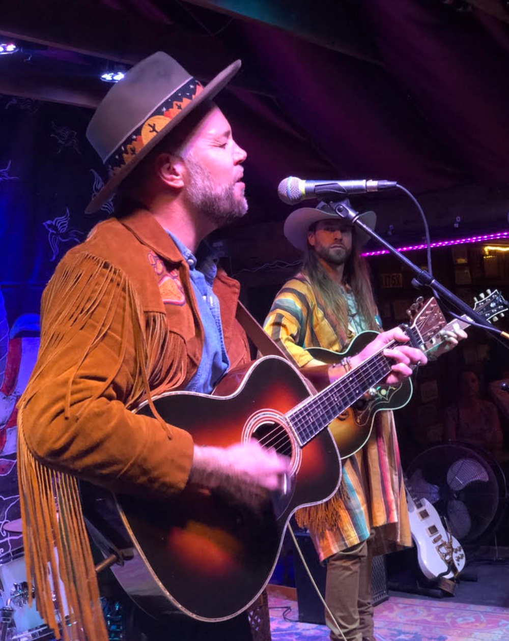 Australian musician performing live in a custom-made Western hat with chainstitch embroidery by amR