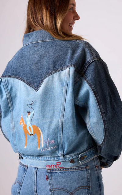 Guest wearing a custom Levi’s denim jacket embroidered live during the Lottie Rae activation