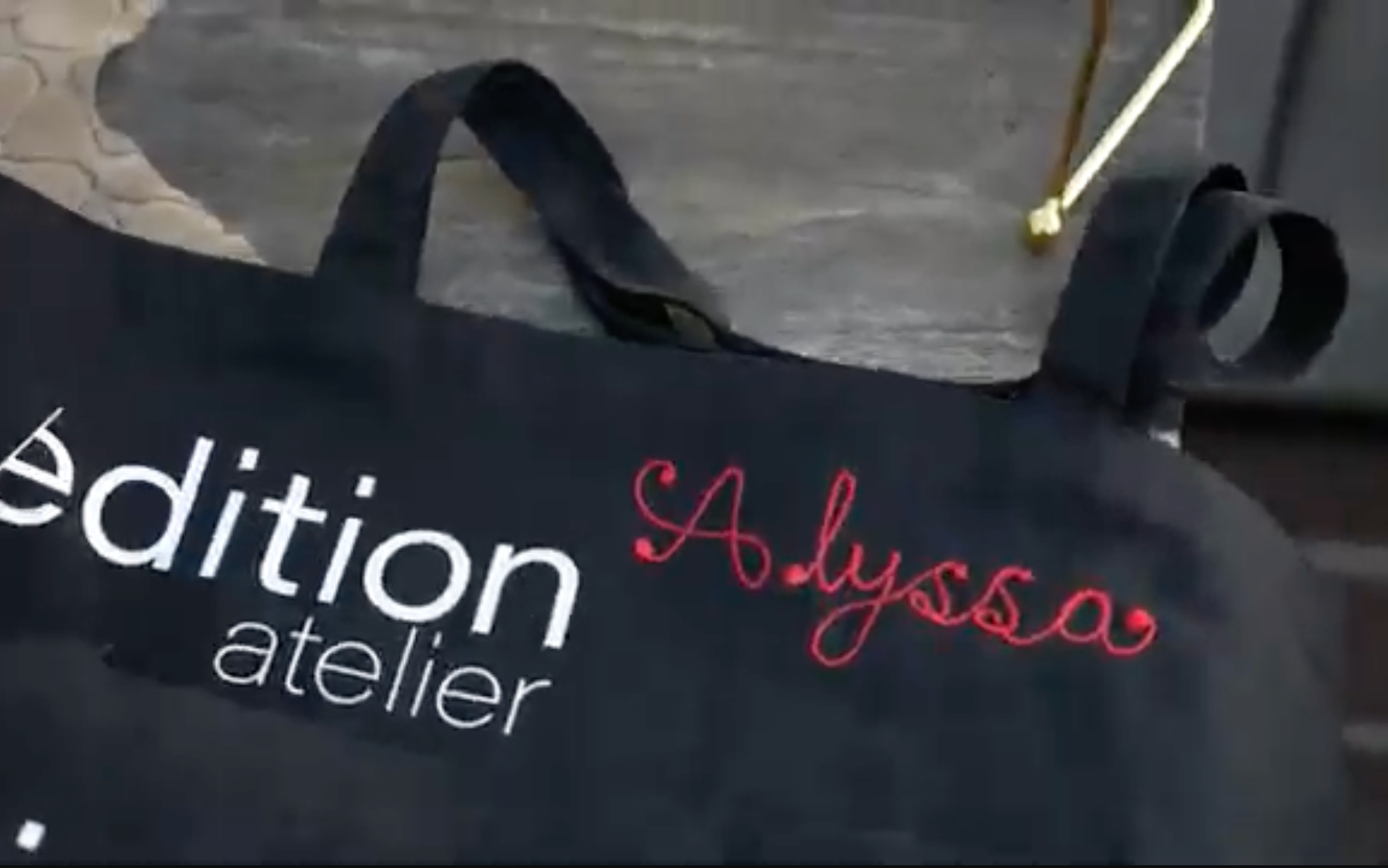 Custom Edition Atelier tote bag with hand-guided chainstitch embroidery at a Beverly Hills, Los Angeles brand event.