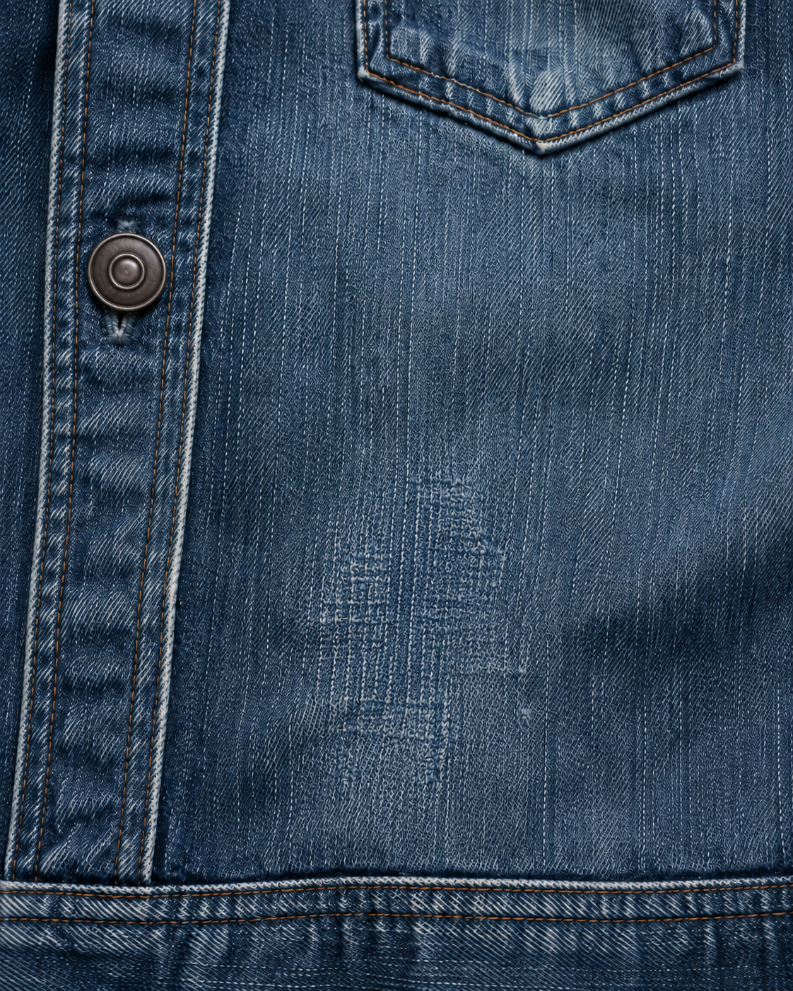 Blue denim jacket after professional darning repair, with indigo-toned stitching blended naturally into the worn denim in Los Angeles.