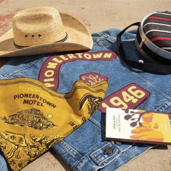 Custom Pioneertown denim jacket with western patches, bandana and cowboy hat in California
